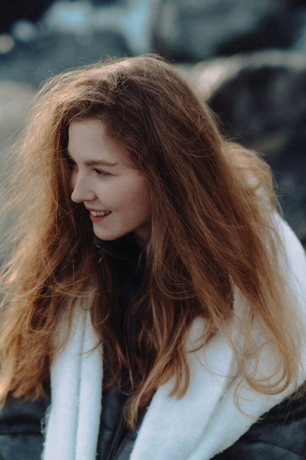 Portrait of a woman with long hair smiling warmly