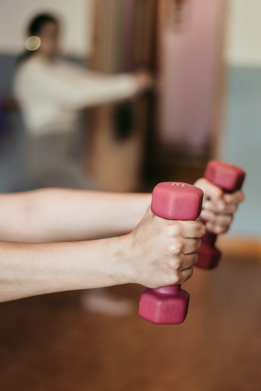 Group fitness class with smiling people exercising together in a bright studio